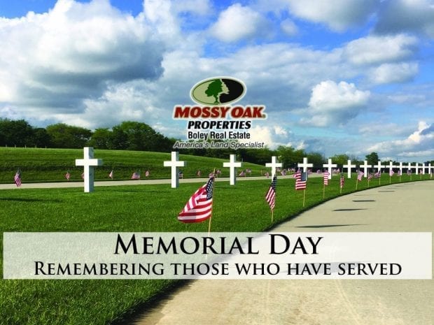 Memorial Day - Remembering Those Who Have Served - white crosses along a field with American flags along a walkway next to it